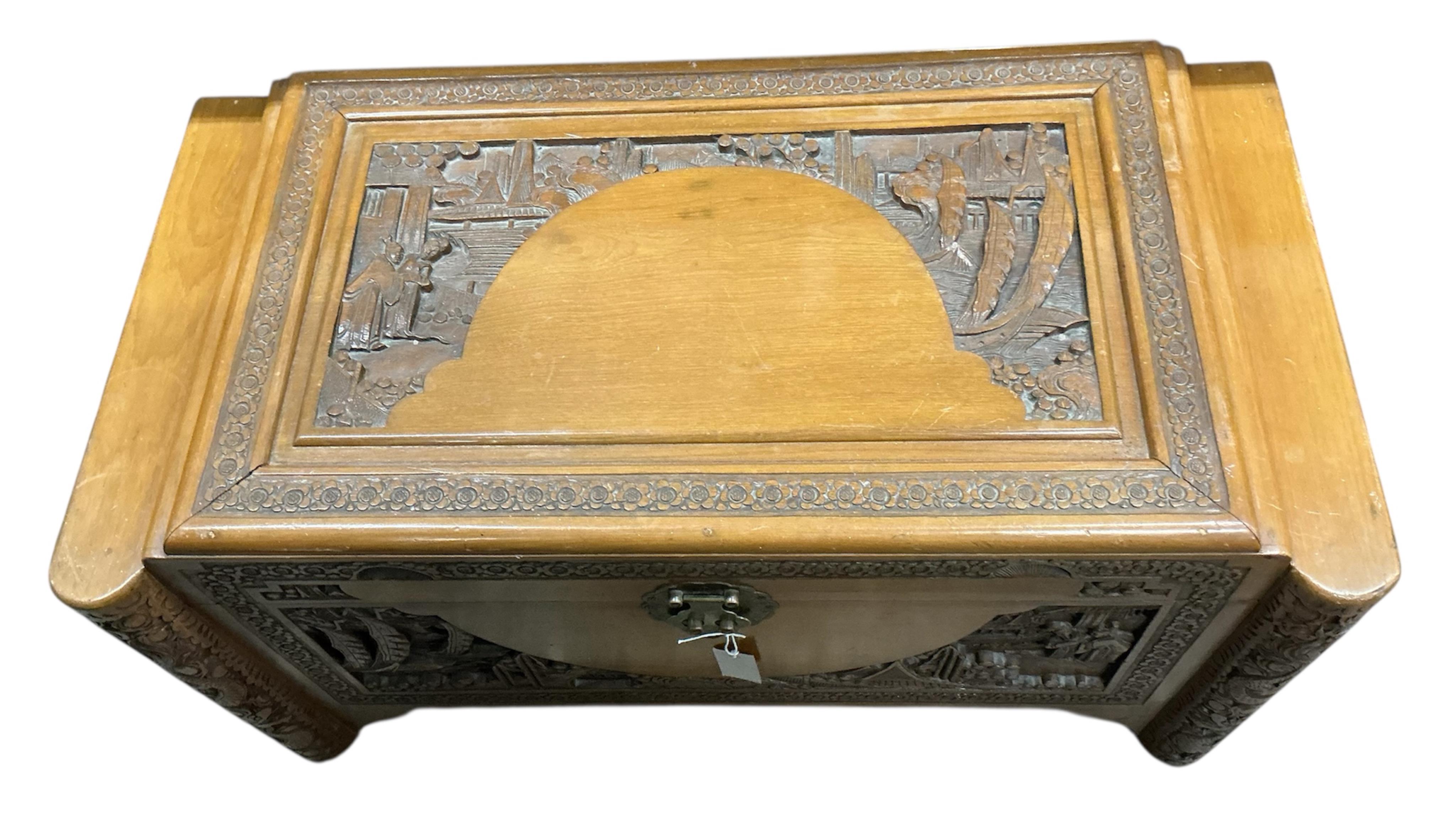 A Chinese carved camphorwood trunk, width 93cm, depth 50cm, height 49cm